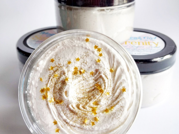 A few jars of white sugar scrub with gold glitter and stars on the top.
