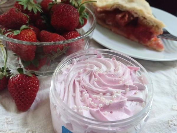 An image of a jar of Ichigo whipped soap, arranged with strawberries and pie.