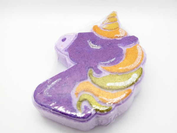 A photo of a bath bomb shaped like a unicorn, painted in Halloween colors.