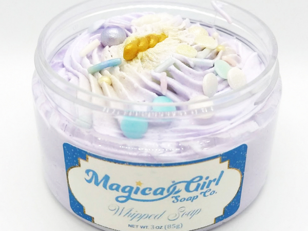 A photo of an open-lidded jar of "Dreamy" soap.