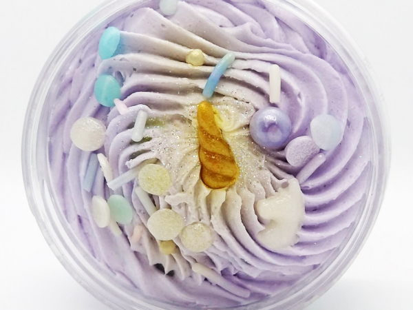 A photo of an open-lidded jar of "Dreamy" soap.