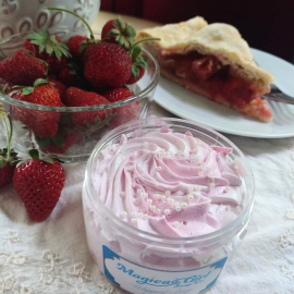 An image of a jar of Ichigo whipped soap, arranged with strawberries and pie.