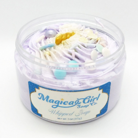 A photo of an open-lidded jar of "Dreamy" soap.