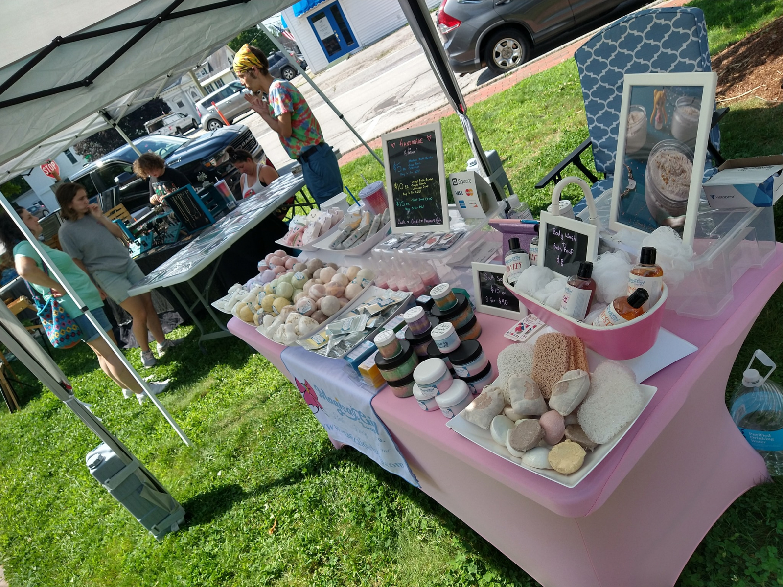A photo of our table setup at the summer market. It includes a variety of bath bombs, soaps, and scrubs. 